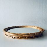 Round mirror in vintage wicker