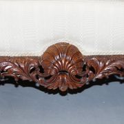 Three-seater canapé carved from solid walnut with claw feet.