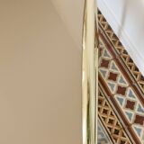 Pair of bedside tables with gold metal and mirrored glass top.