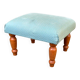 Vintage footstool made of solid wood and blue fabric.