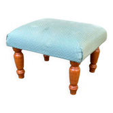 Vintage footstool made of solid wood and blue fabric.
