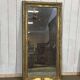 19th-century mirror in gilded wood and plaster.
