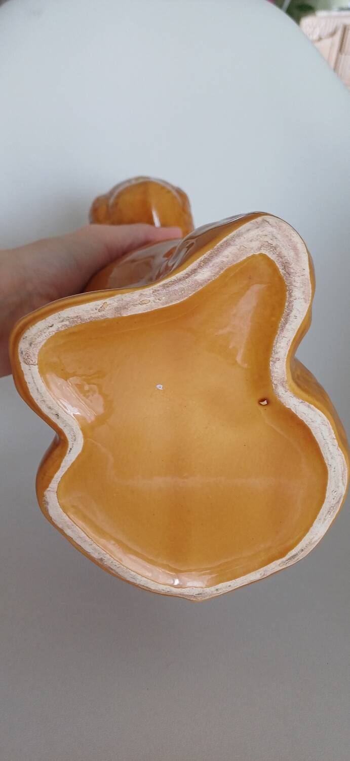 Ancient ceramic pitcher in the shape of a poodle.