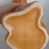 Ancient ceramic pitcher in the shape of a poodle.