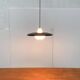 Minimalist metal and glass pendant lamp in mid-century style.
