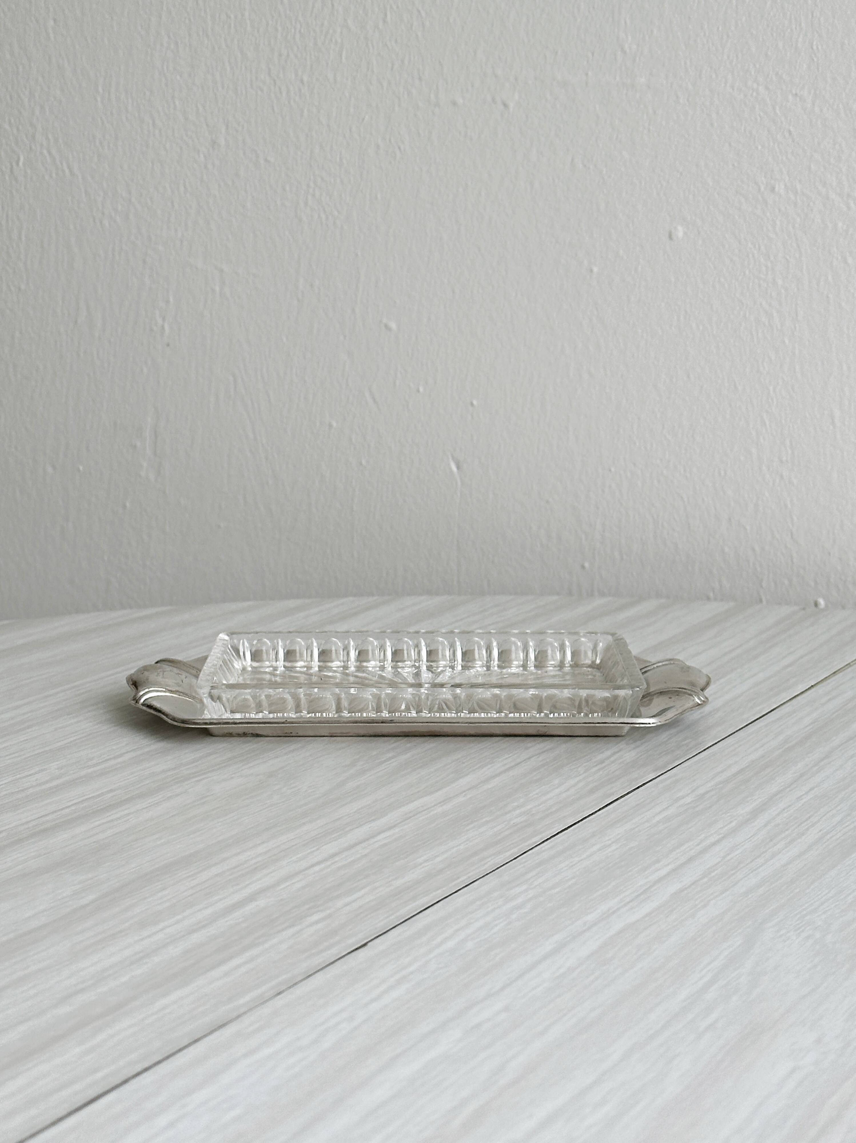 Metal butter dish and thick rectangular glass bowl.