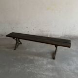 Dark brown wood and black cast-iron antique garden bench with weathered solid-wood seat