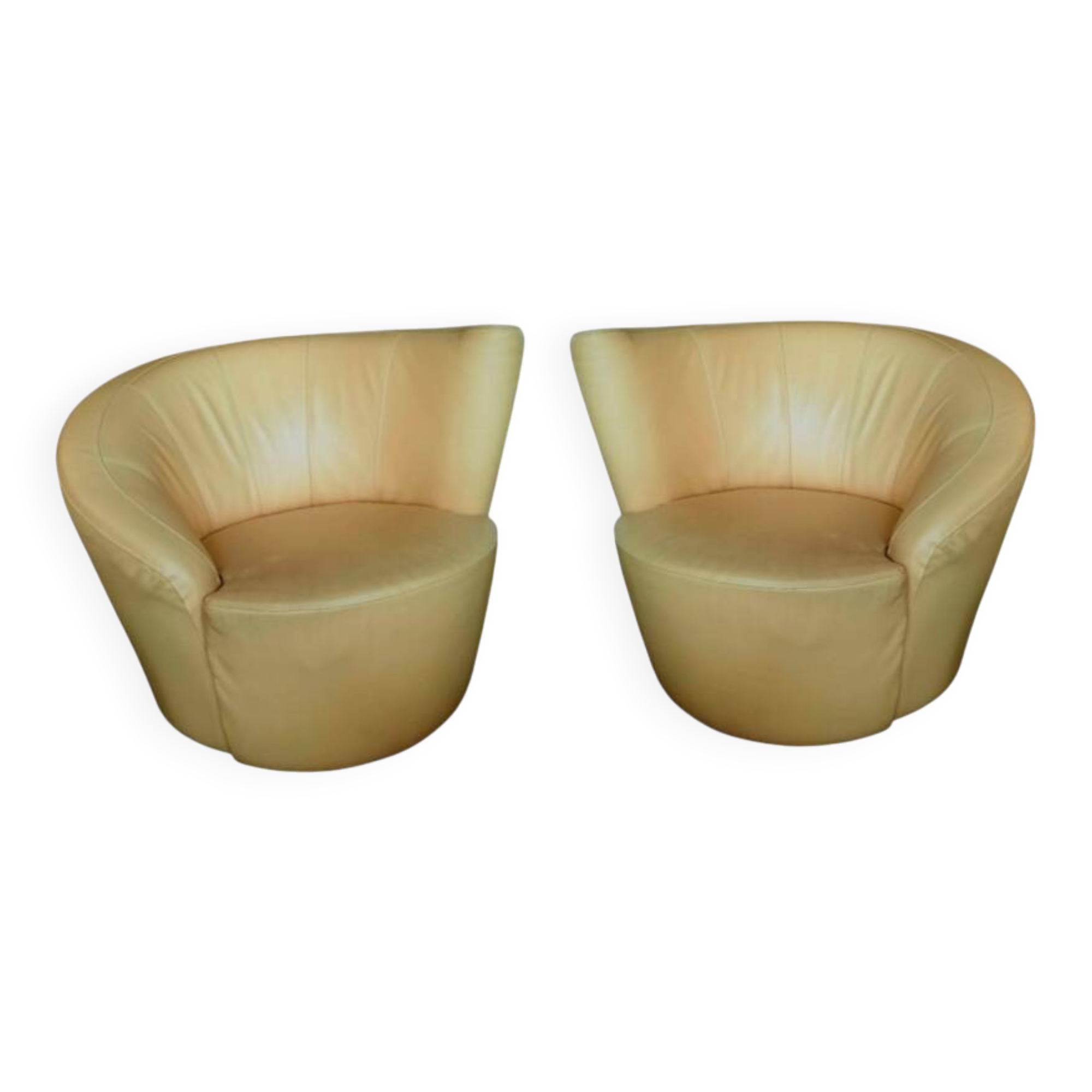 Pair of yellow leather swivel armchairs with asymmetrical armrests, circa 1980