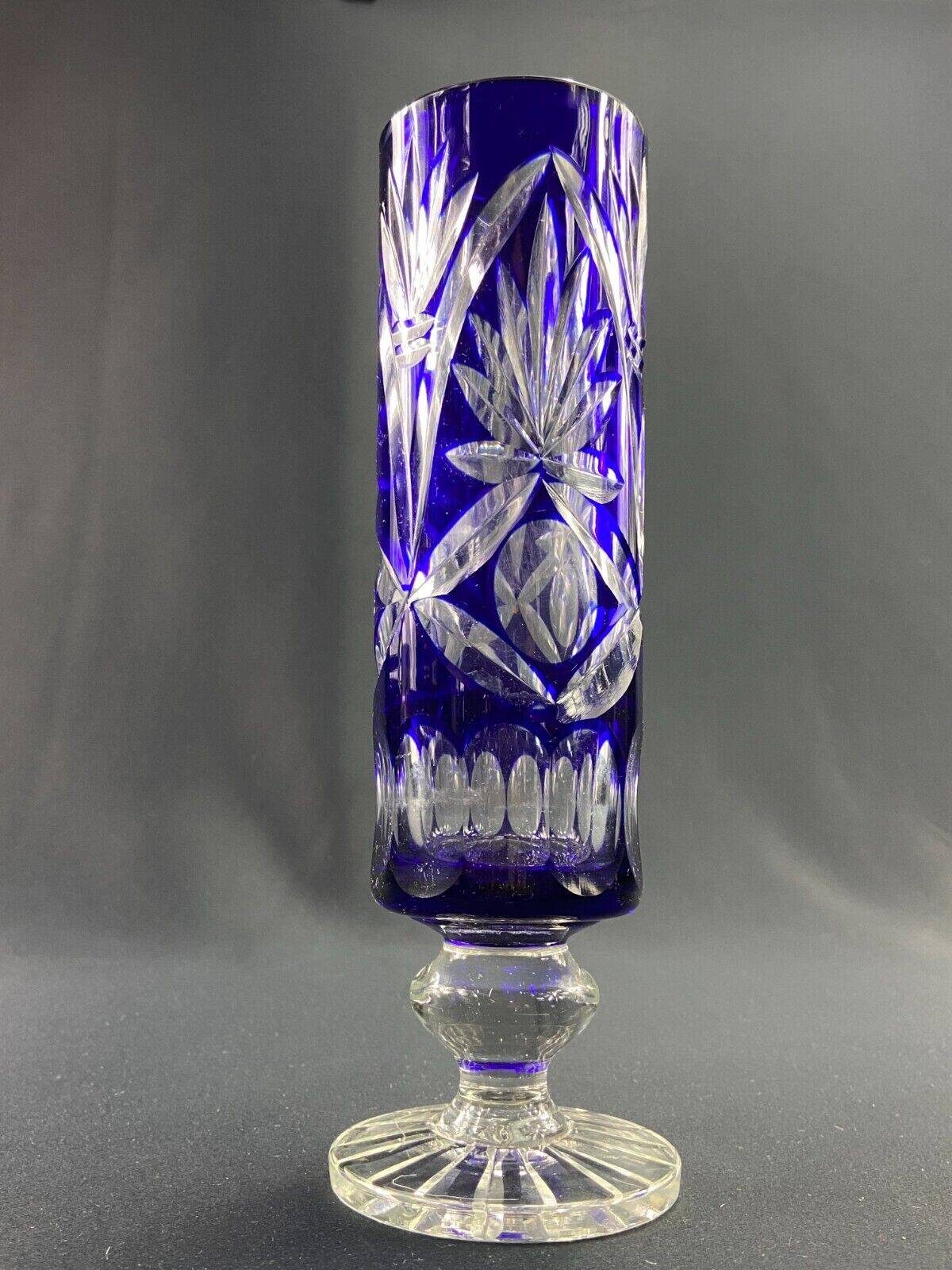 Tubular vase on a pedestal in cut blue Bohemian crystal.