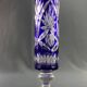 Tubular vase on a pedestal in cut blue Bohemian crystal.
