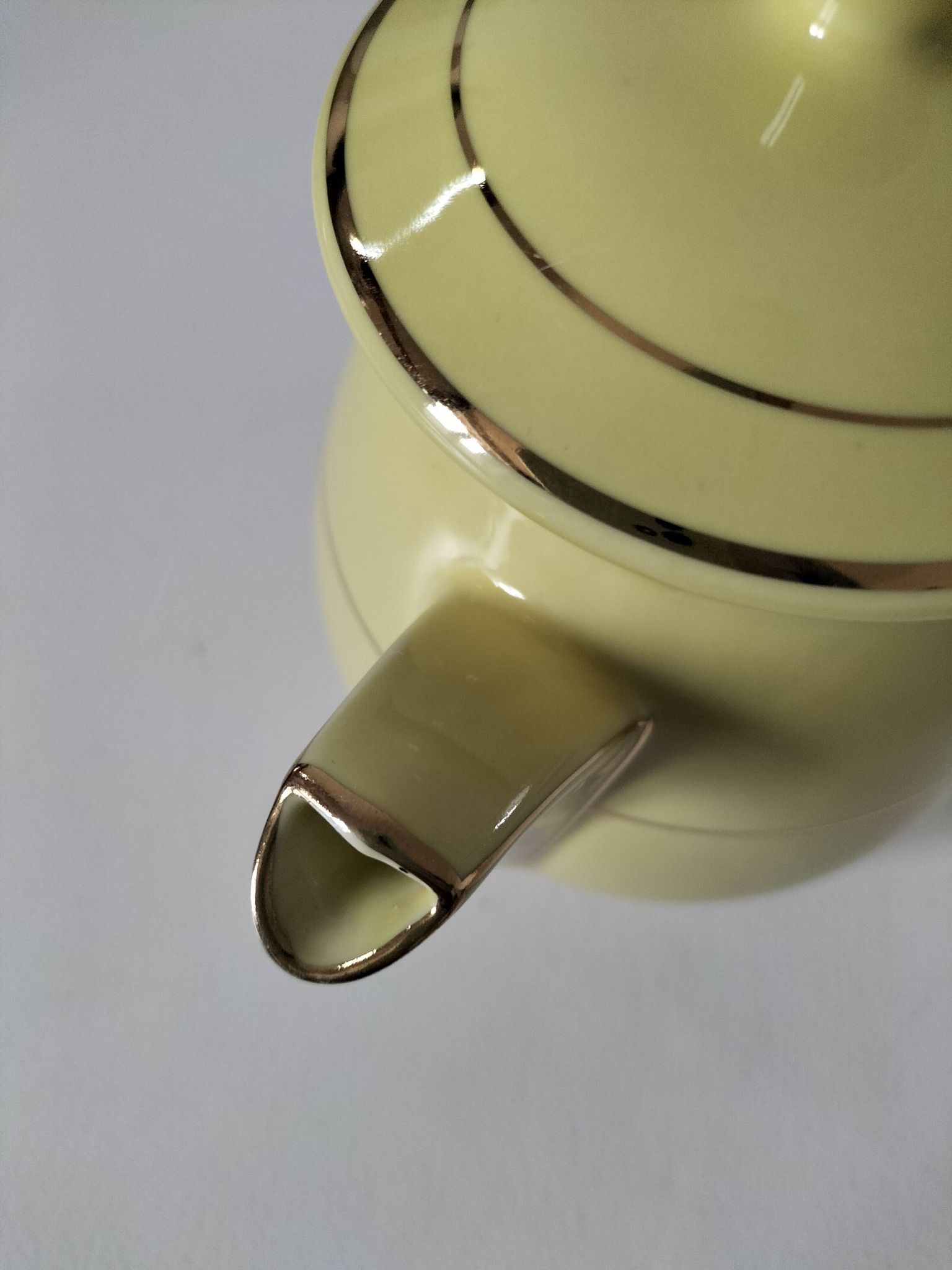 Vintage teapot in pastel yellow earthenware with gold trim