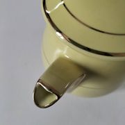 Vintage teapot in pastel yellow earthenware with gold trim