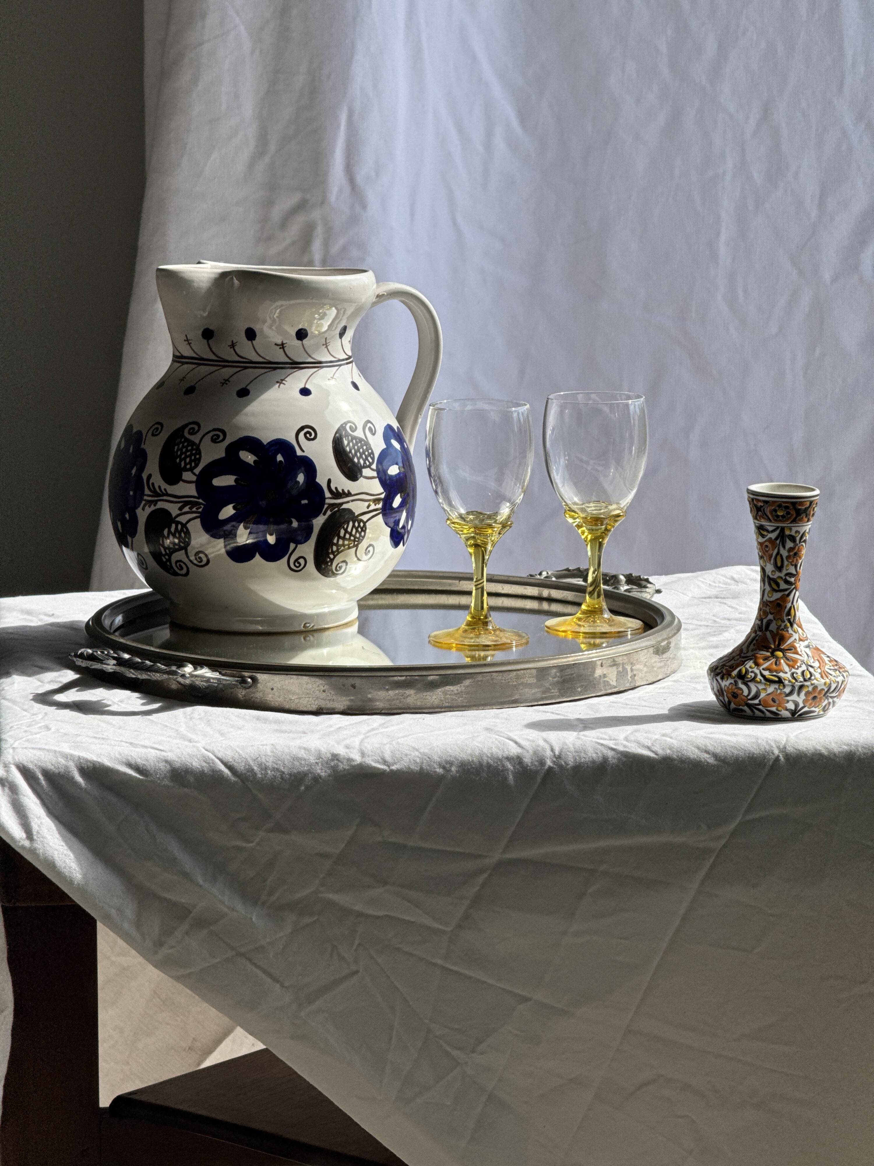 Very large vintage ceramic carafe in white glazed with blue floral decoration.