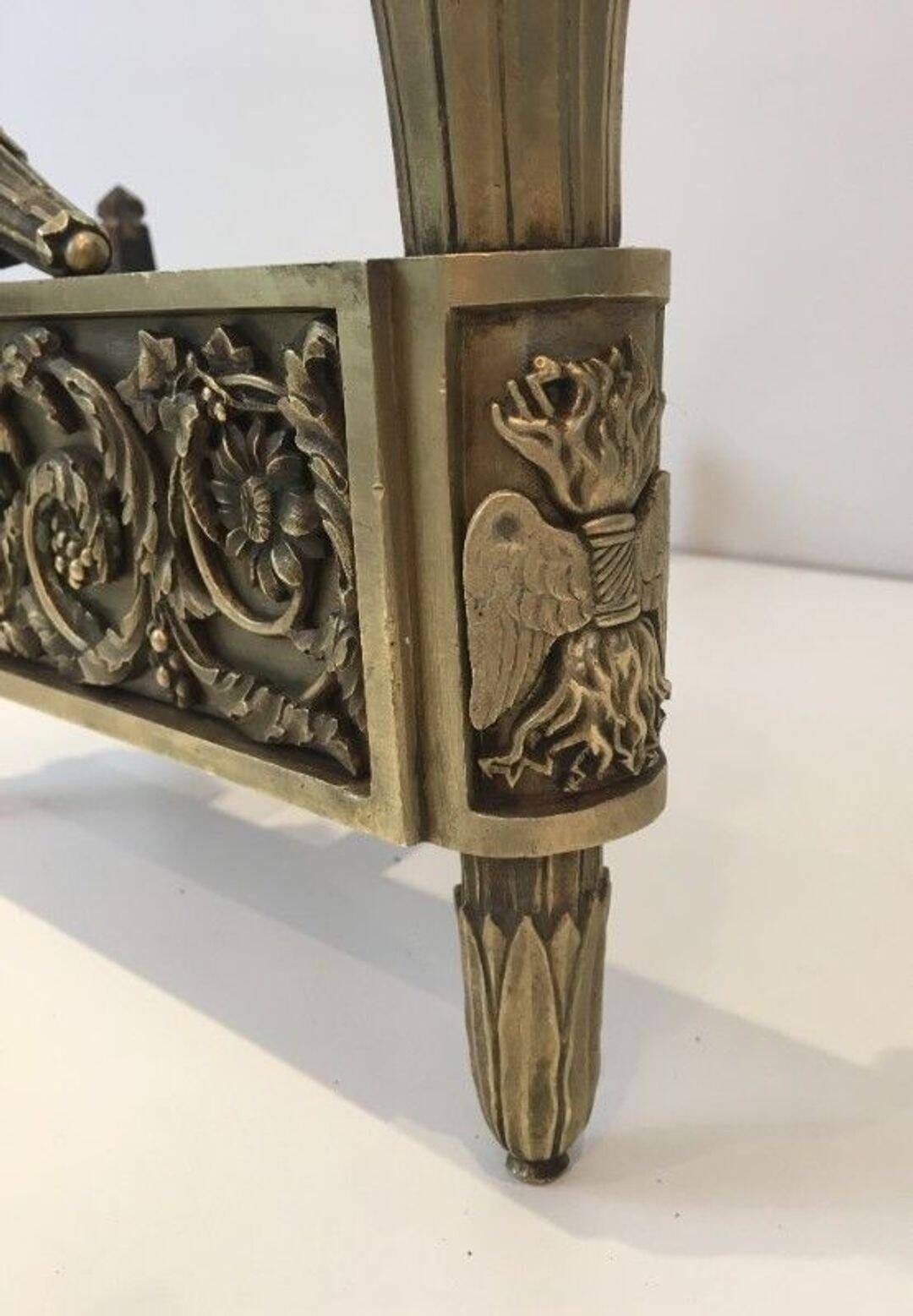 Pair of Empire Period Chenets in Chiselled Bronze with Torches and Leaf Frieze