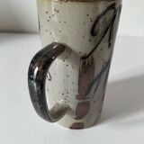 Glazed stoneware mug with free decoration, vintage pottery work.