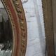 Golden oval mirror
