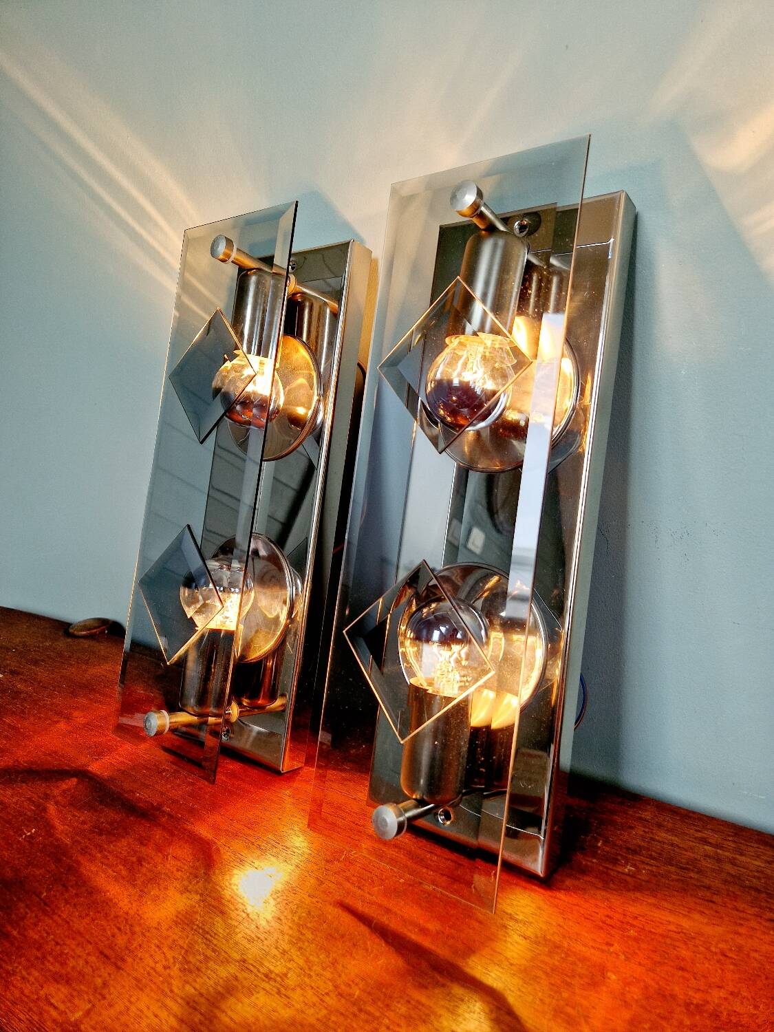 Pair of chrome metal and smoked glass wall sconces, 1970s.