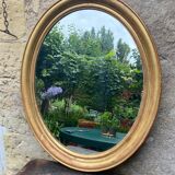 Golden oval mirror