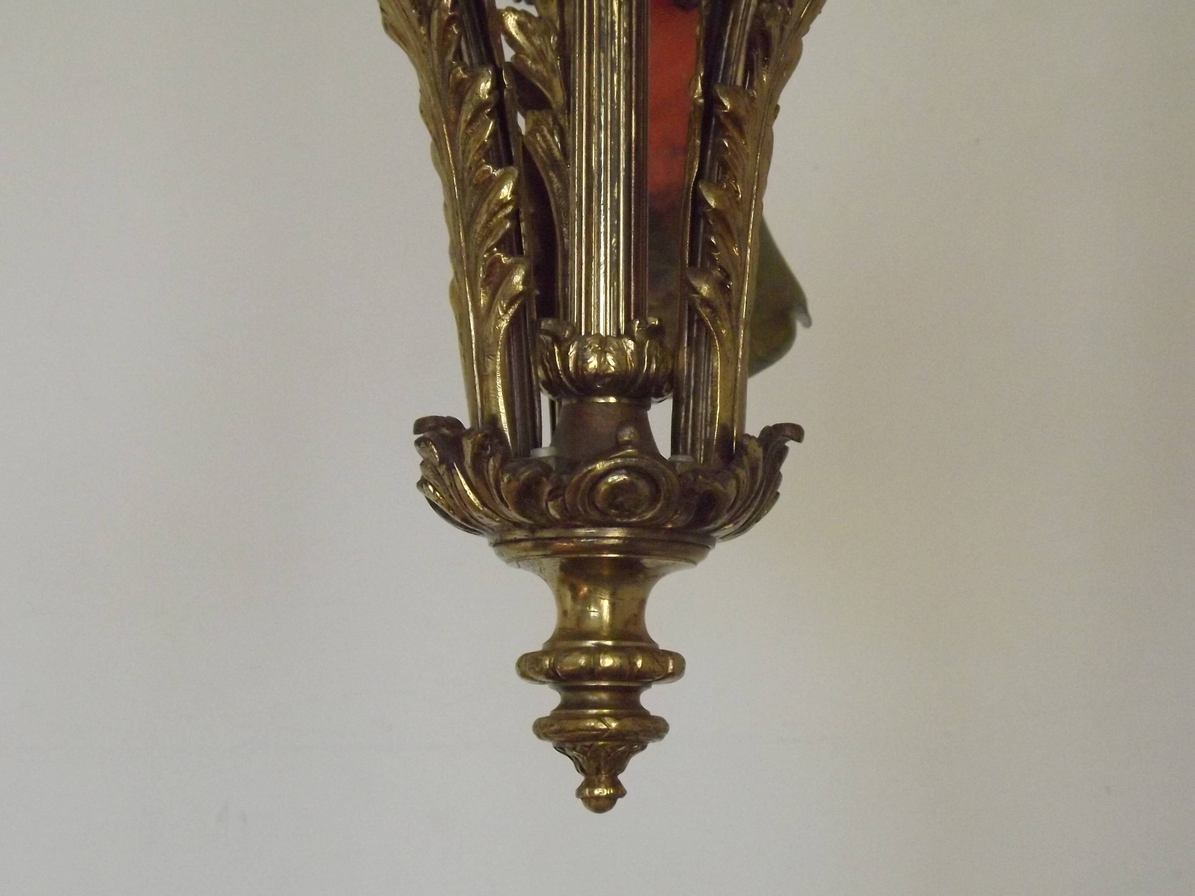 Art Nouveau three-light chandelier in bronze with orange and green glass shade, France.