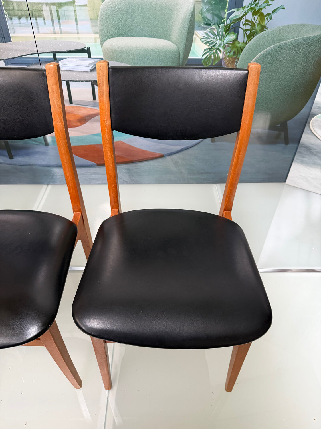 4 Scandinavian chairs in teak and black faux leather.