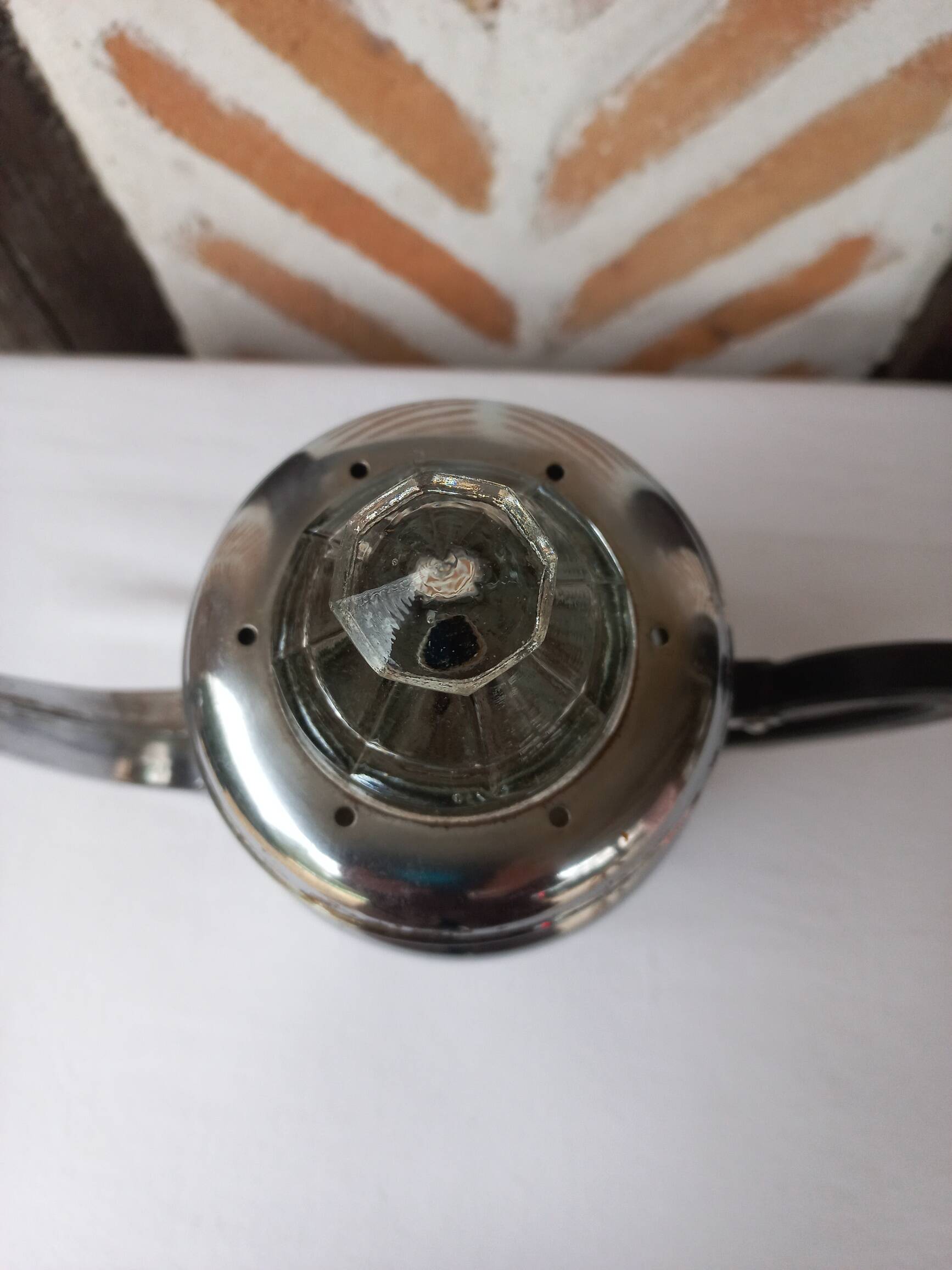 Silver metal coffee maker with glass cap