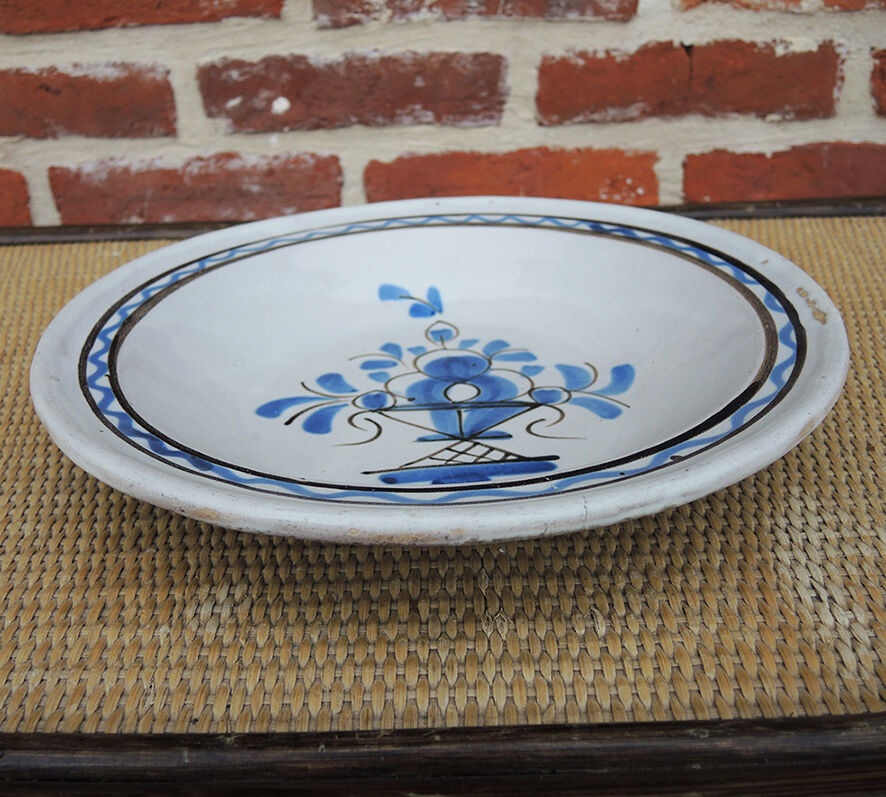 Old large round black ceramic dish