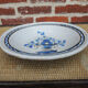 Old large round black ceramic dish