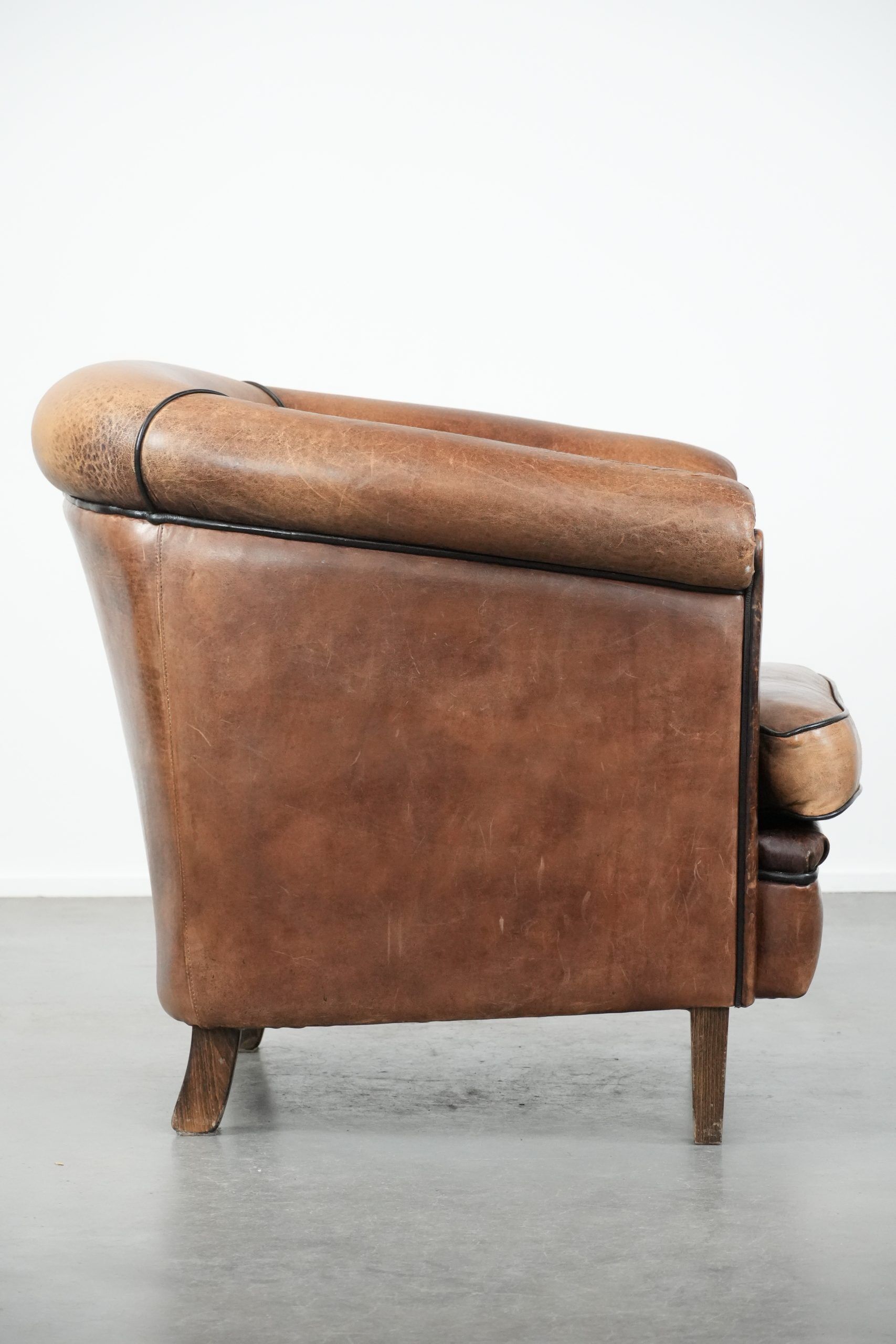 Sturdy vintage sheepskin club armchair with a beautiful patina