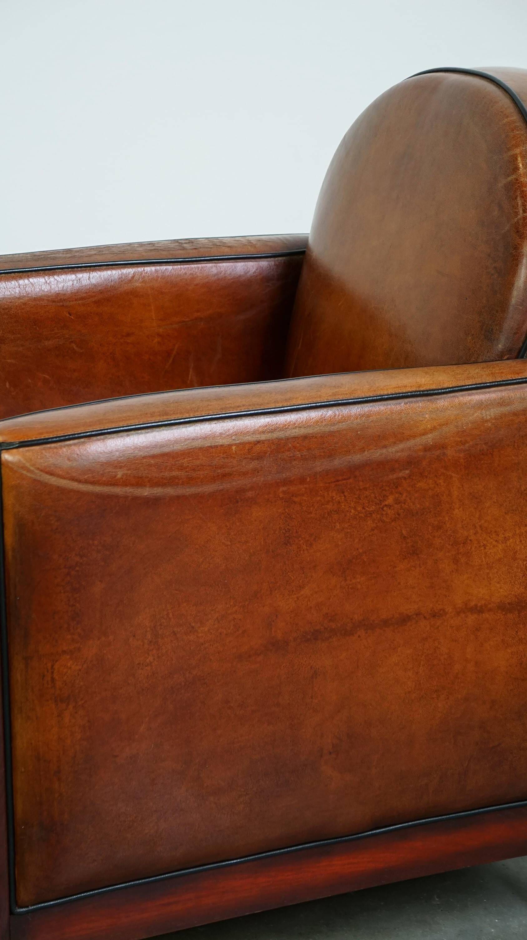 Sheepskin Art Deco design armchair with wood and beautiful cognac-colored leather
