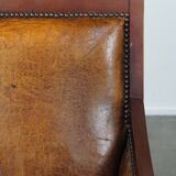 Sheepskin and wooden vintage Art Deco design armchair in a cognac color