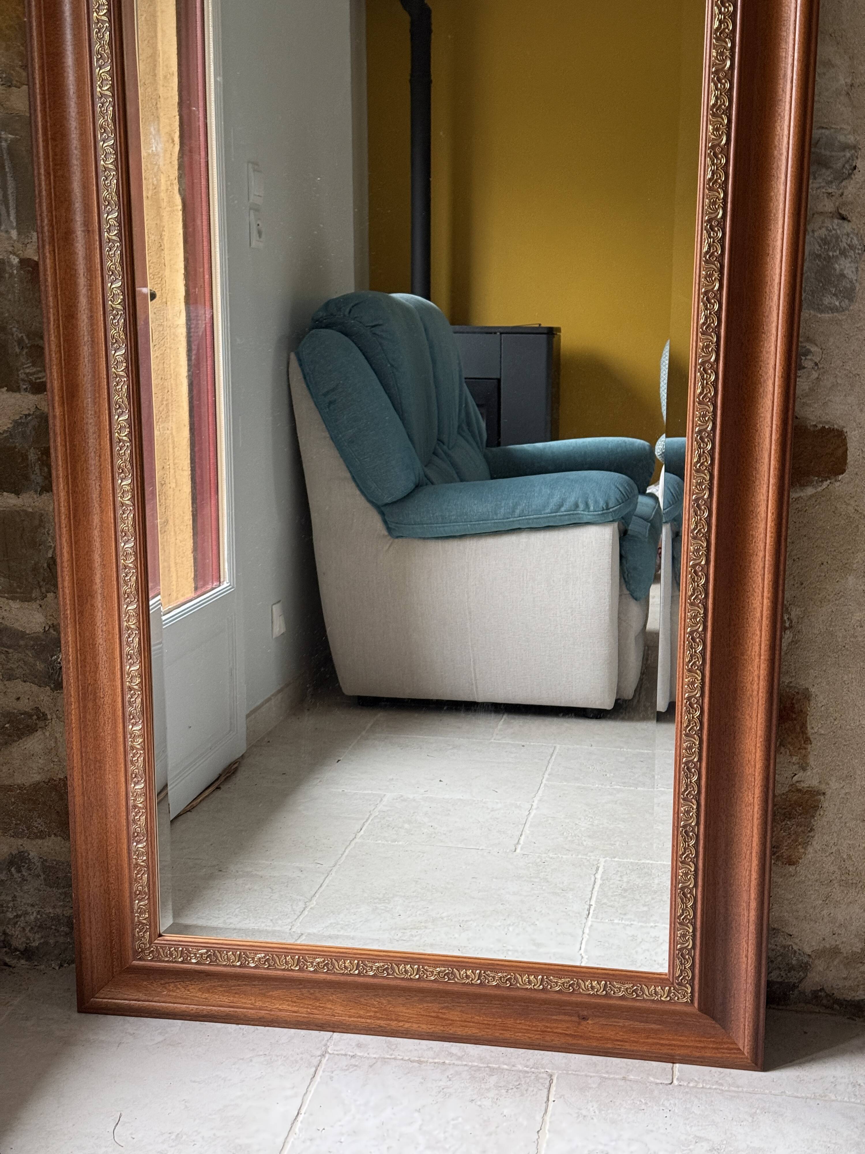 Large bevelled tabletop mirror in carved gilded wood.