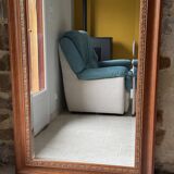 Large bevelled tabletop mirror in carved gilded wood.