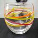 4 vintage Luminarc water glasses with coloured spiral line patterns.