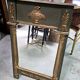 Empire-style mirror in deep green lacquered wood richly enhanced.
