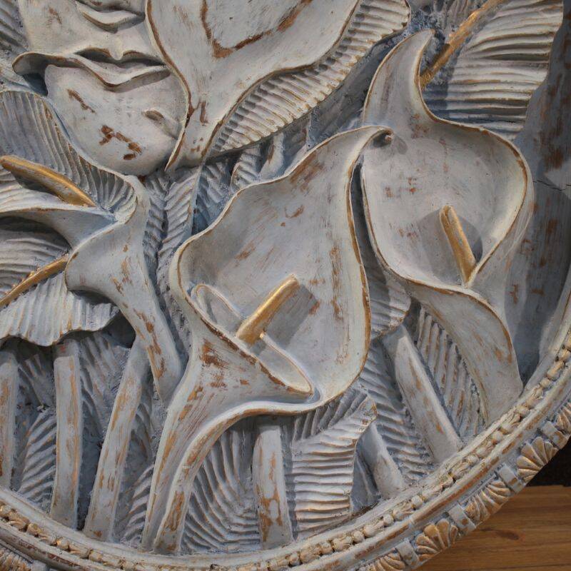 Bas-relief sculpture, stylized face with flowers, 20th century