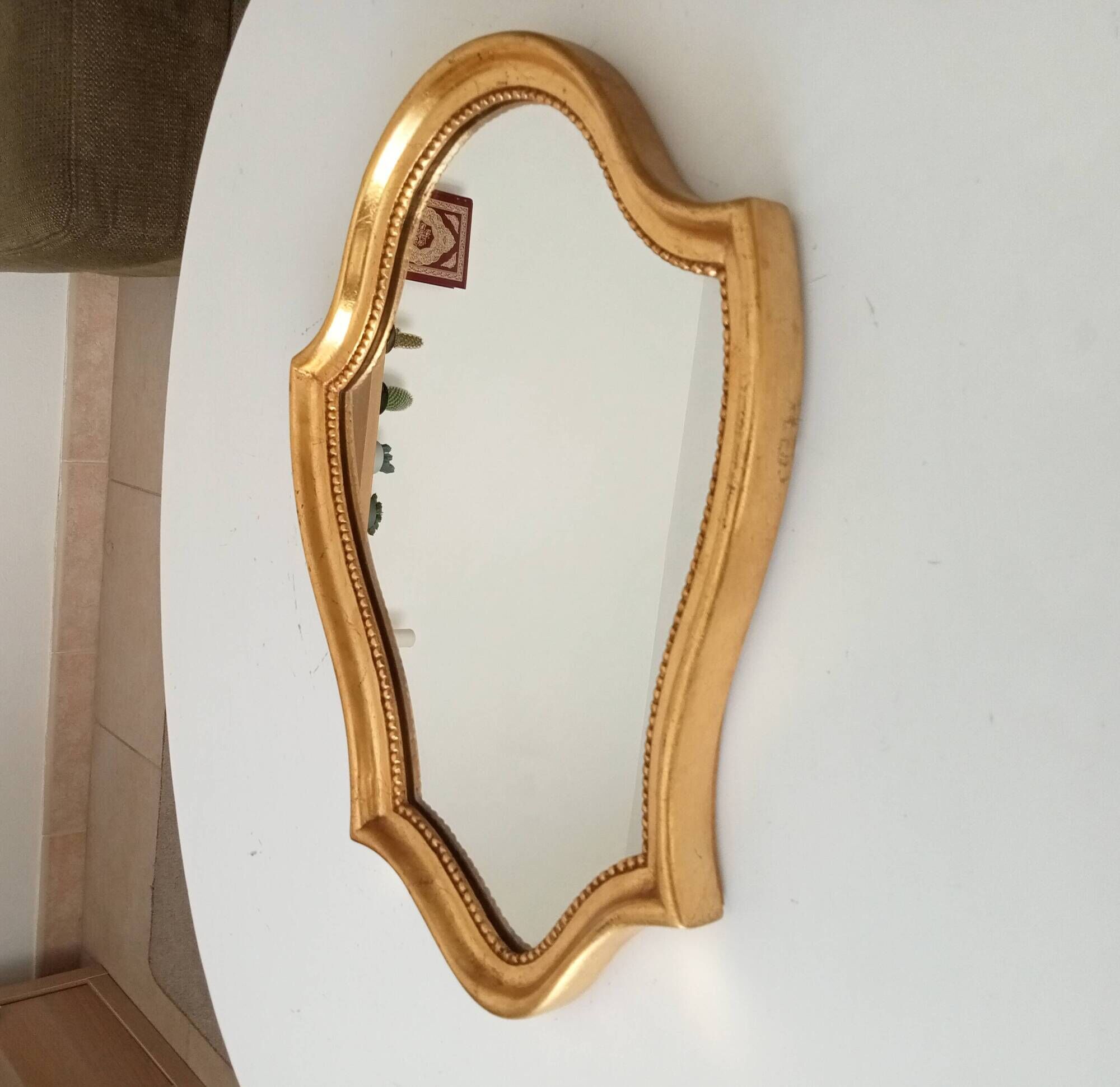 Vintage baroque mirror in gilded wood in the Louis XV style.
