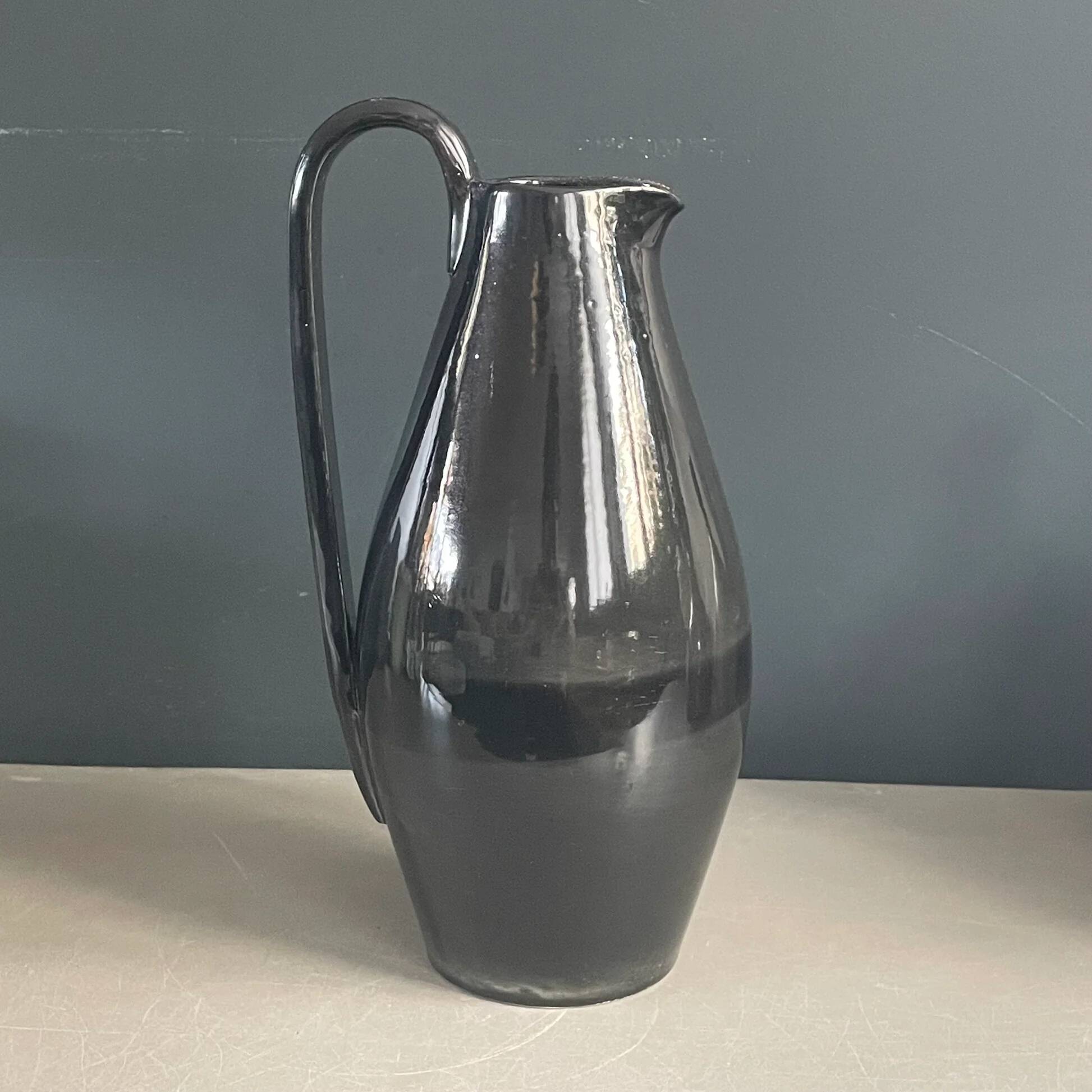 Black glazed ceramic pitcher signed M Azouit
