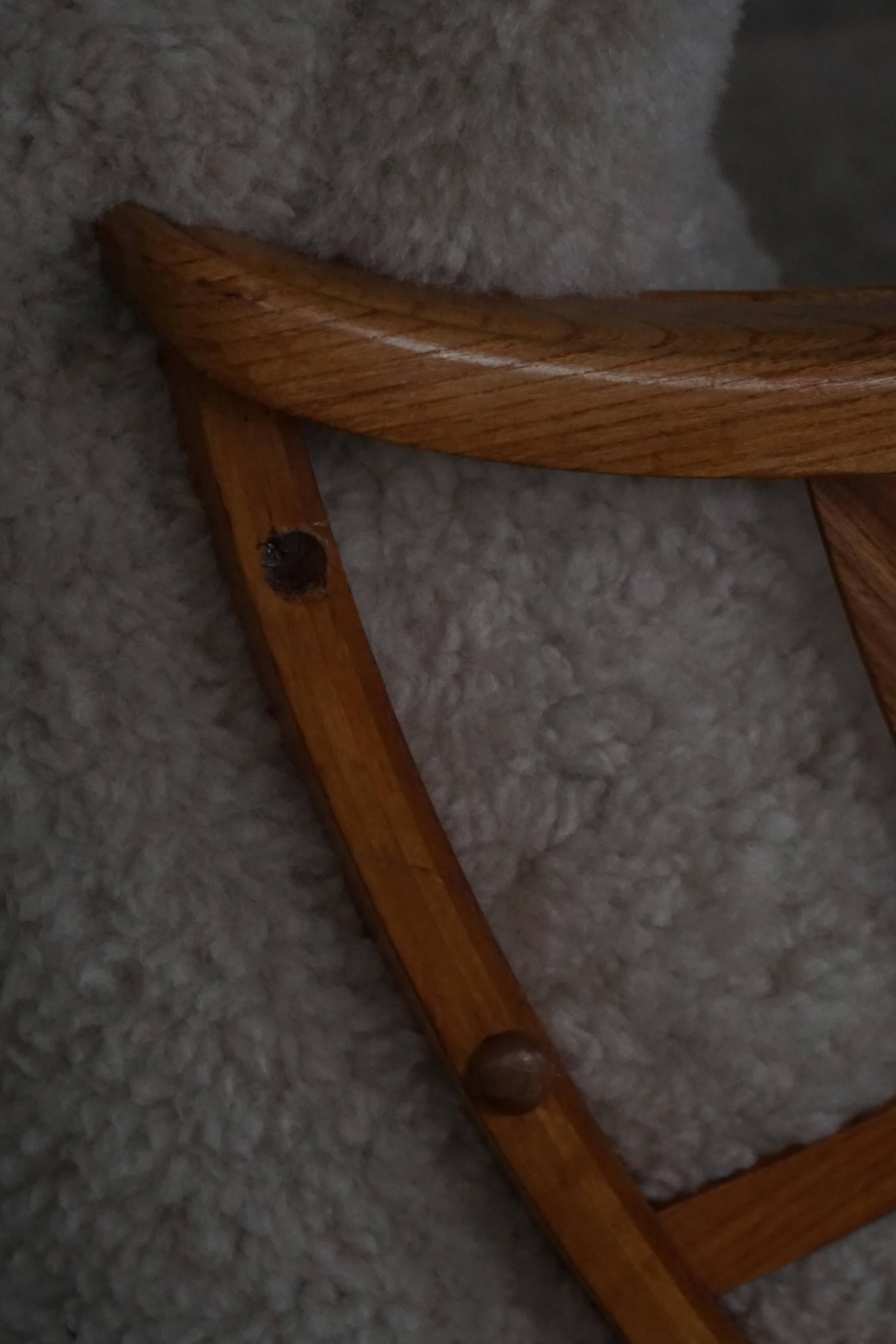 Pair of modern Swedish lounge chairs, shearling sheepskin and elm, 1940s.