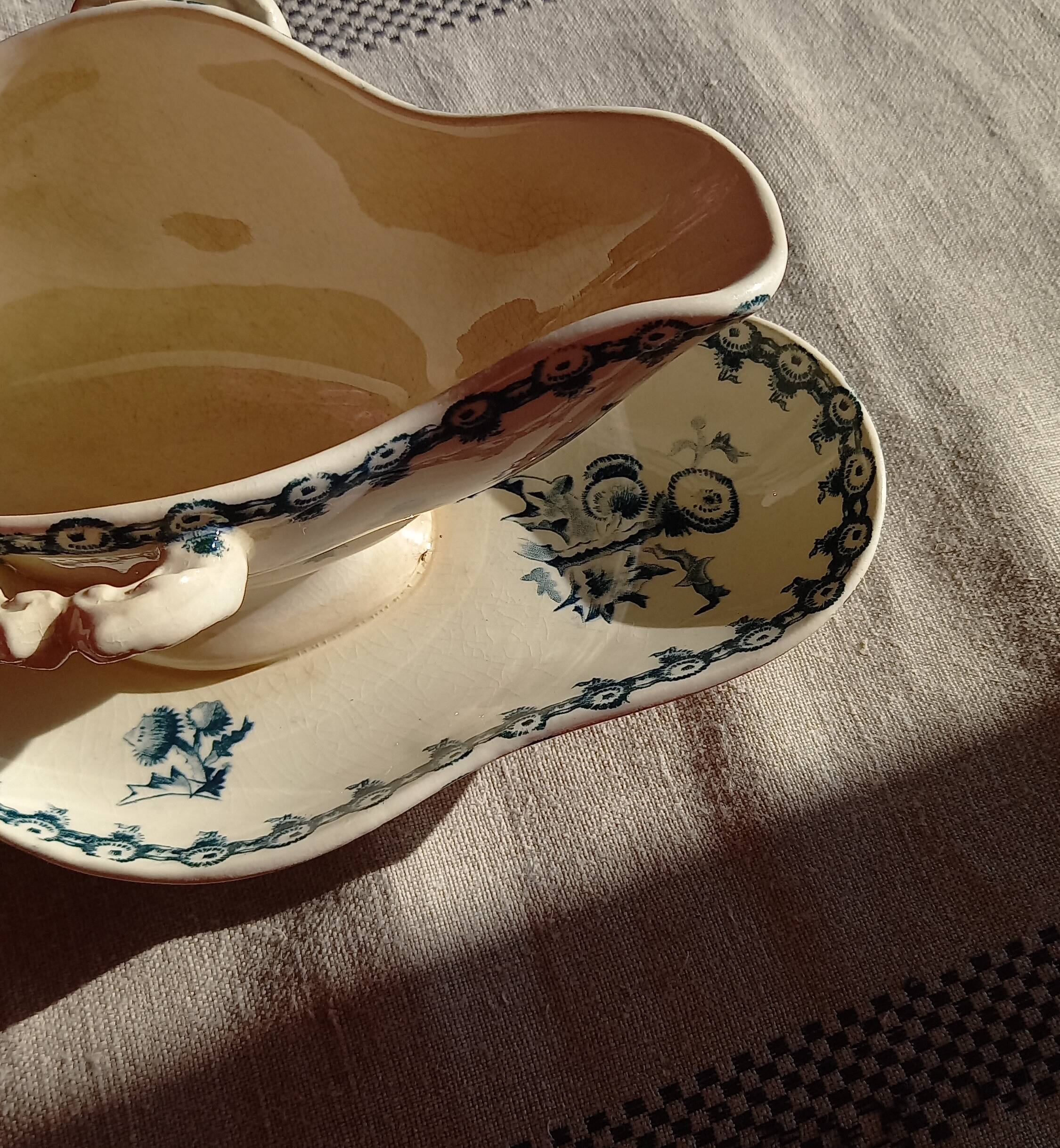 Old gravy boat on frame in terre de fer earthenware by gien, “chardons” model in blue-green