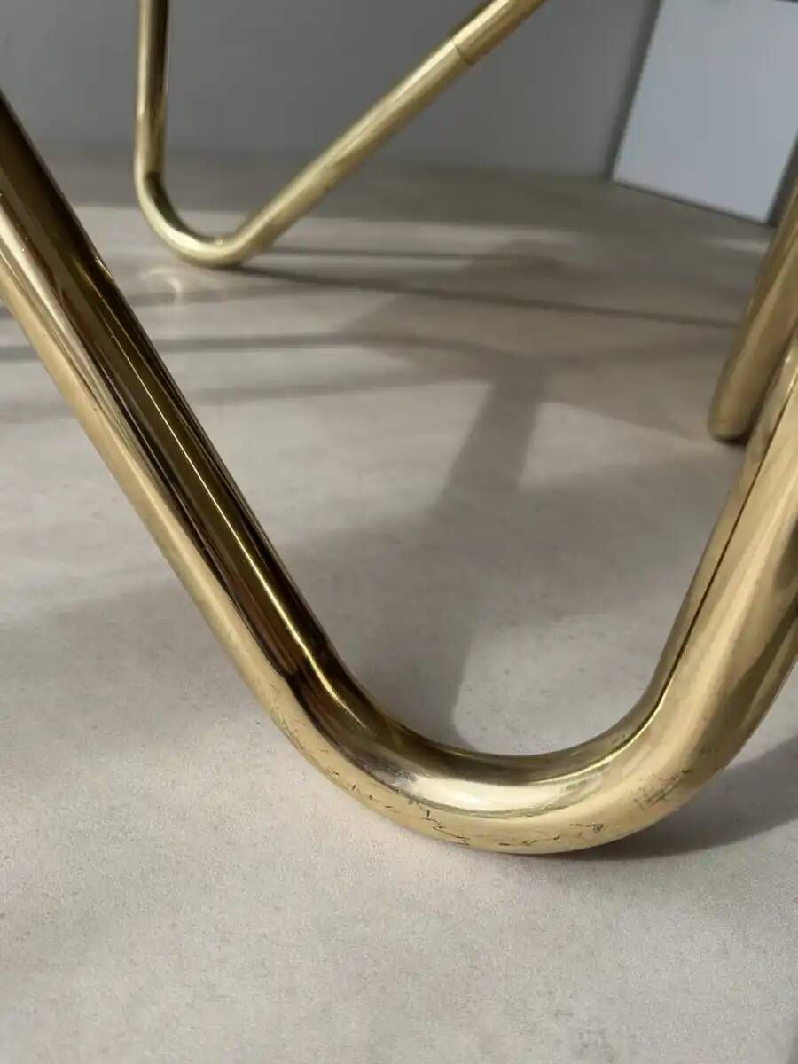 Coffee table with smoked glass and curved metal base