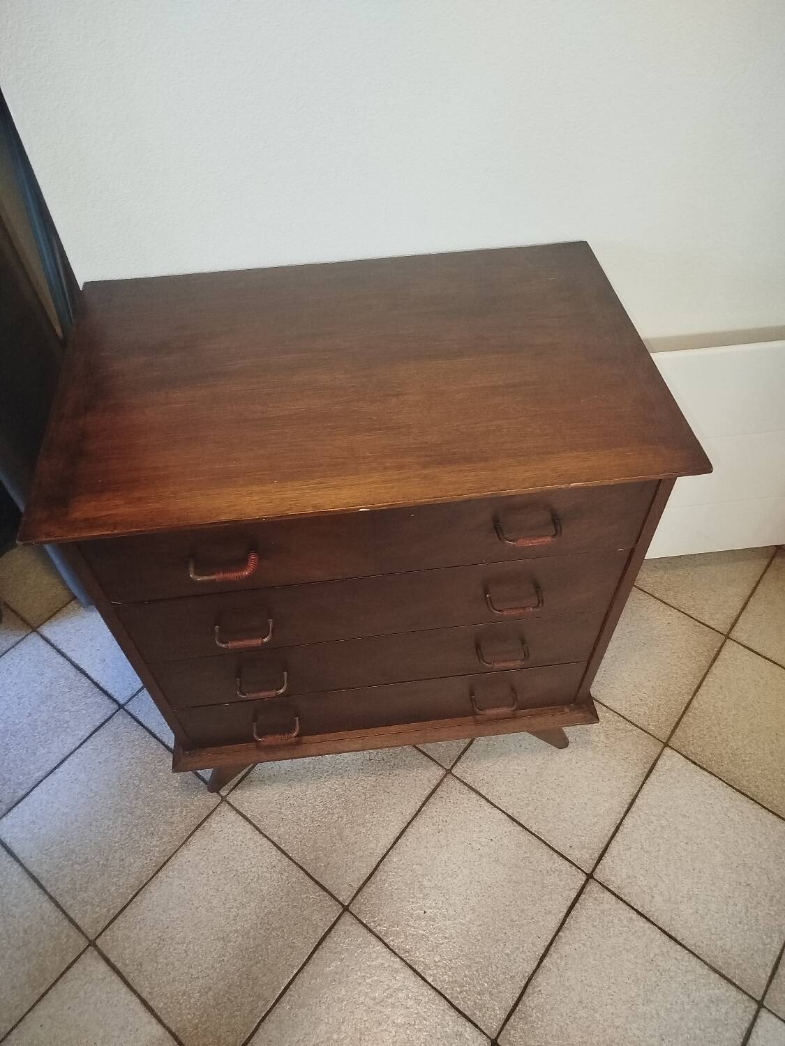 Vintage chest of drawers from the 1950s with wooden legs and a design feature.
