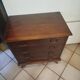 Vintage chest of drawers from the 1950s with wooden legs and a design feature.