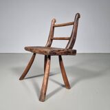 Rustic Wabi-Sabi style accent chair in dark curved hardwood, 1900s.