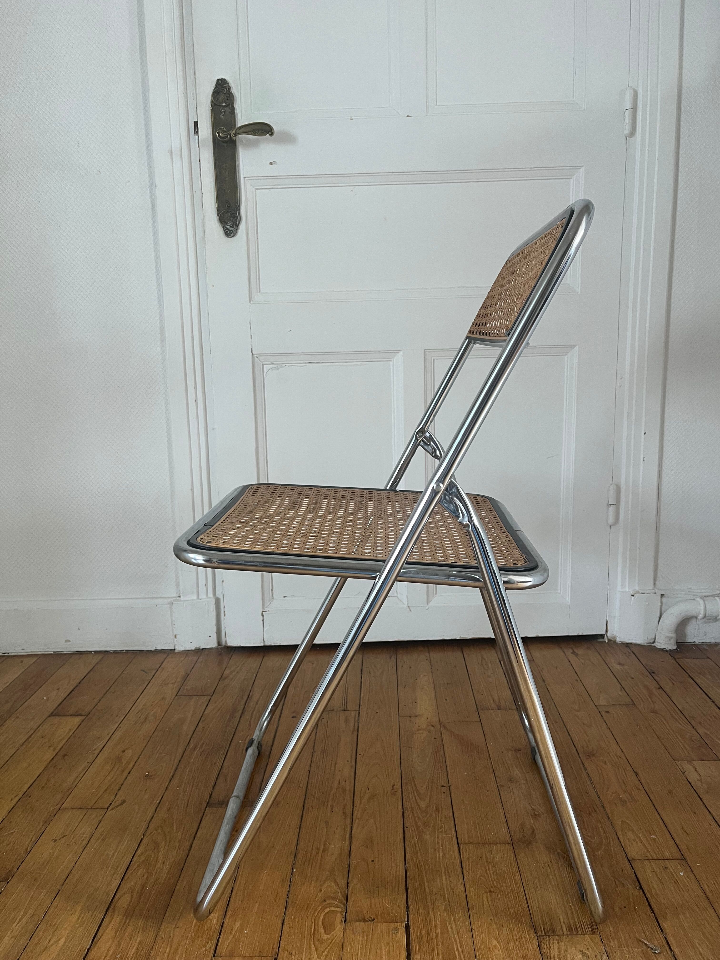 Vintage folding chair in metal and cane.