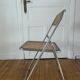 Vintage folding chair in metal and cane.