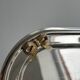 Small stainless steel tray with knot pattern.