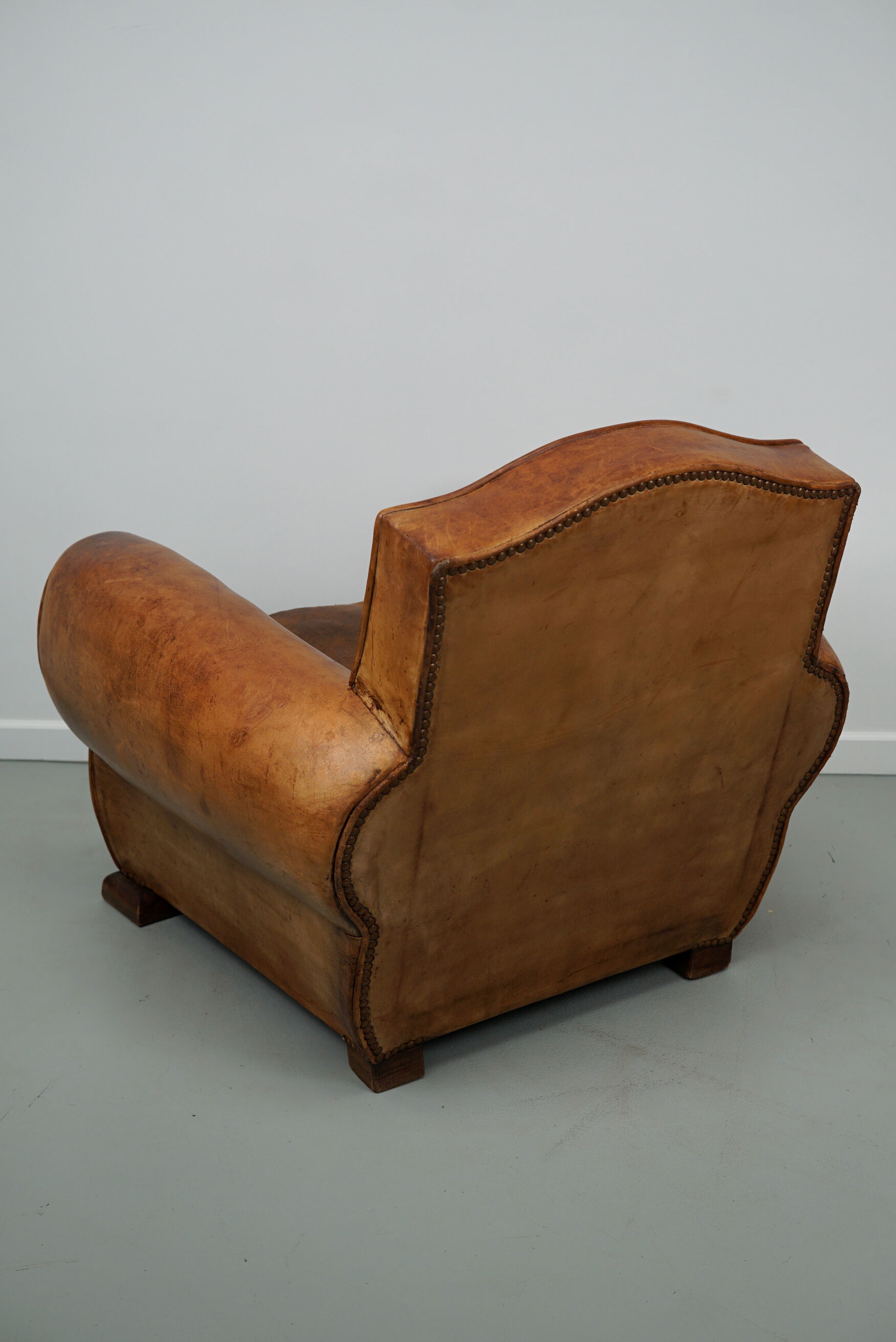French moustache back cognac-colored leather club chair, 1940s