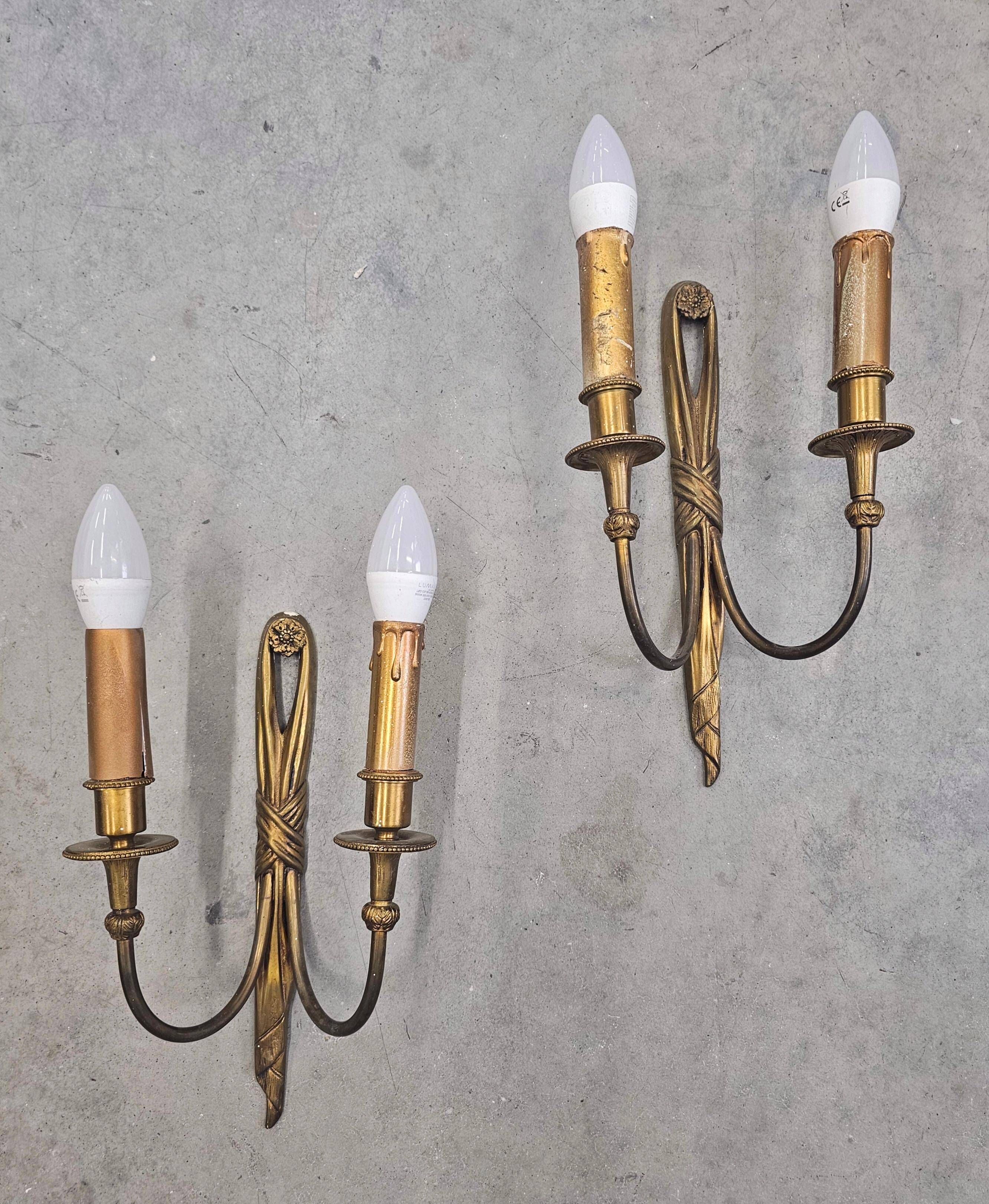 Pair of Louis XVI style bronze wall sconces with bow and tassel, 1940s.