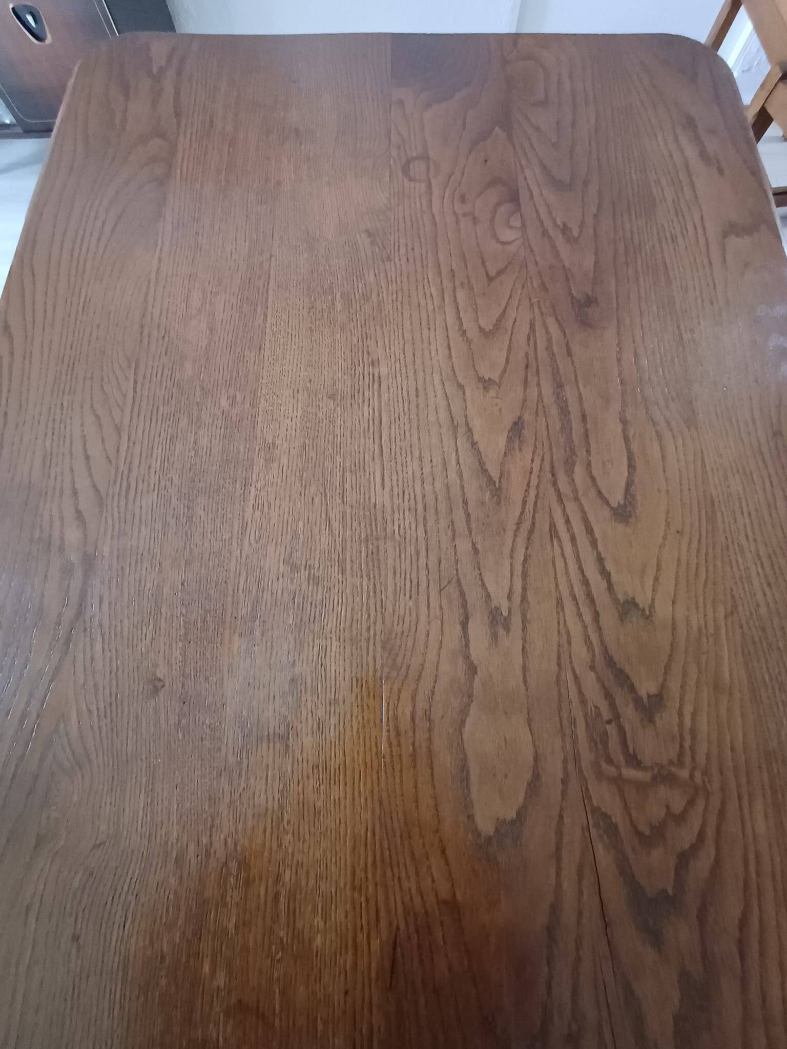 Solid wood dining table with a sculptural base.