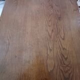 Solid wood dining table with a sculptural base.